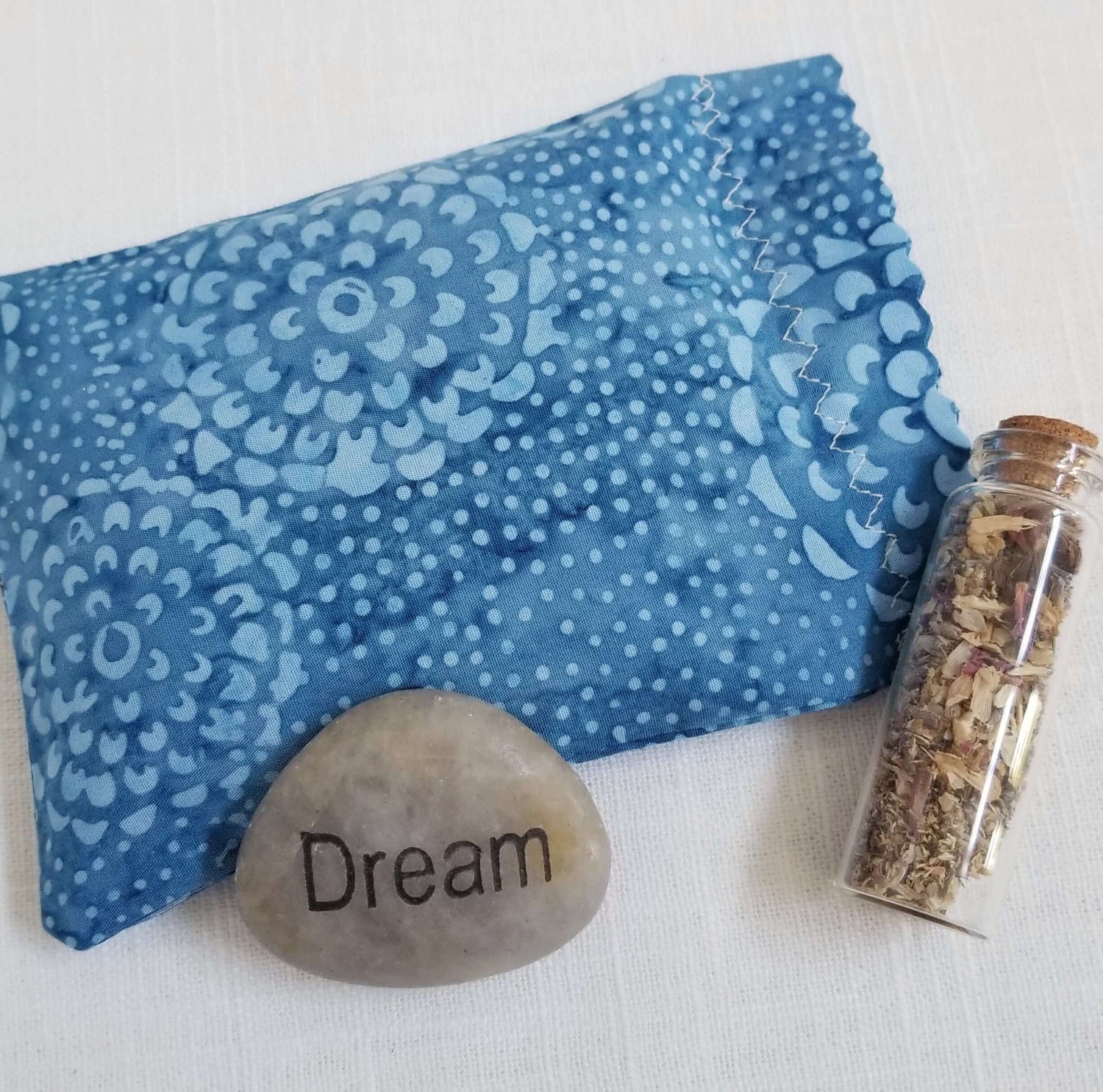 herbal sleep sachet with dream rock and vial of herbs