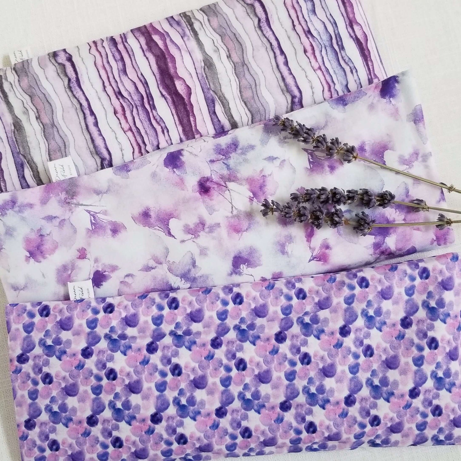 3 lavender eye pillows and dried lavender stems