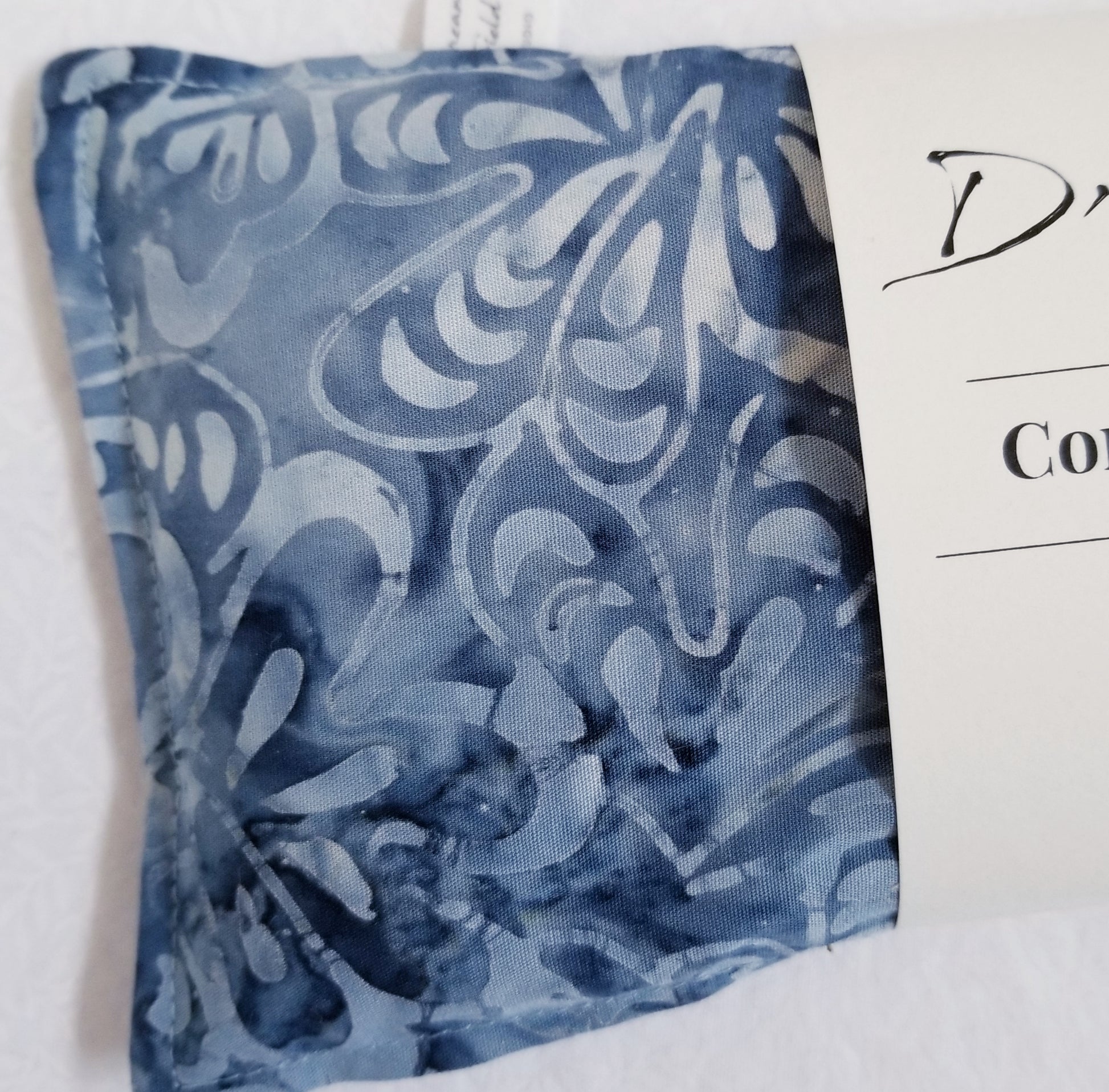 closeup of  blue batik eye pillow with mint and eucaluyptus
