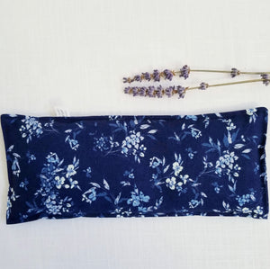 organic lavender eye pillow laid flat with 2 lavender stems