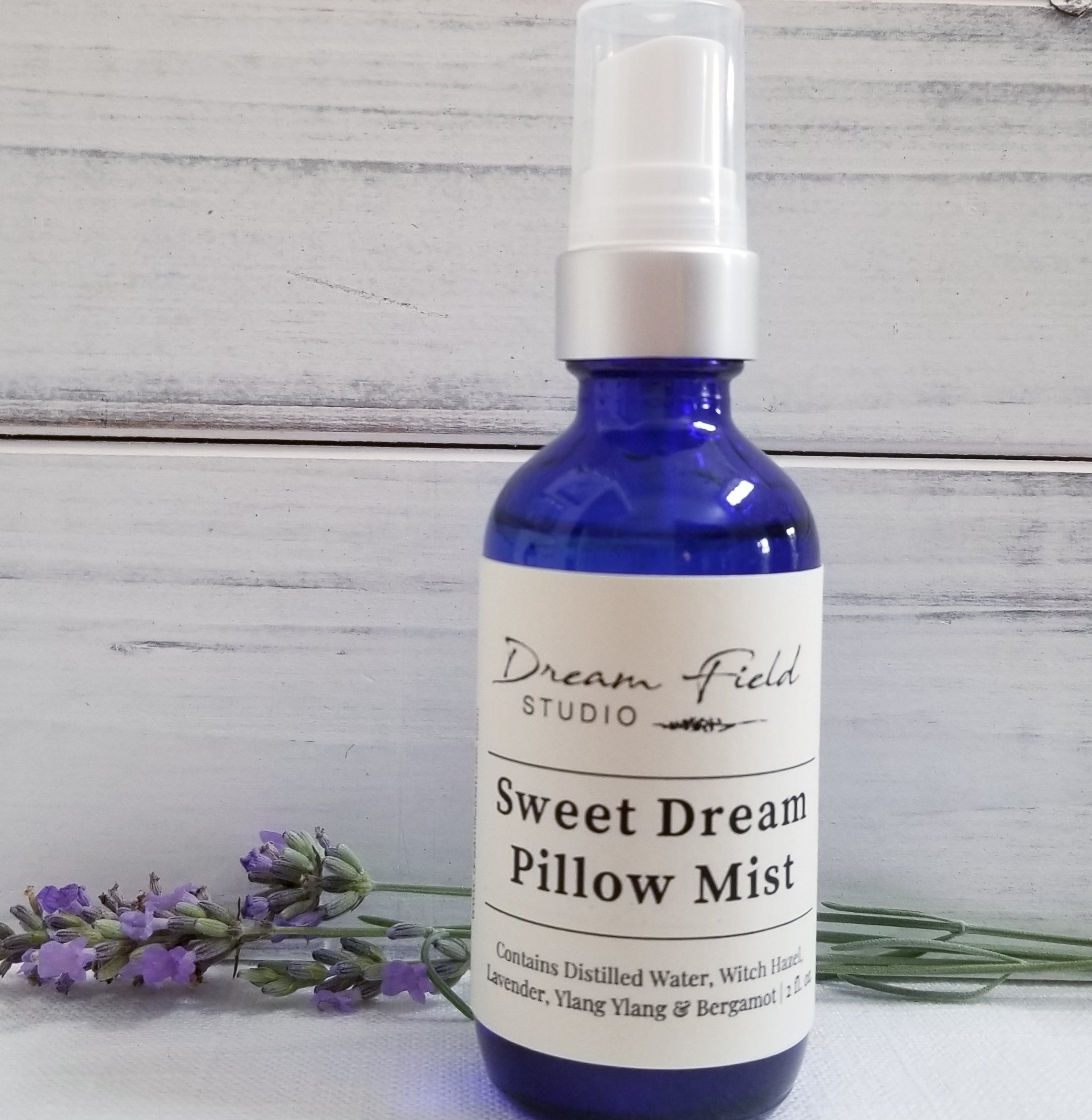 Close up of Sweet Dream Pillow Mist  in a blue glass bottle