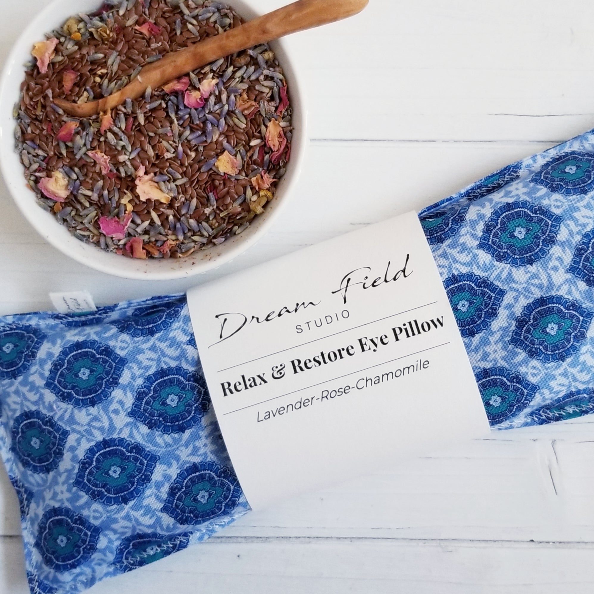 Lavender-Rose-Chamomile eye pillow shown in French Blue Indienne Pattern with bowl of lavender buds and flax seeds