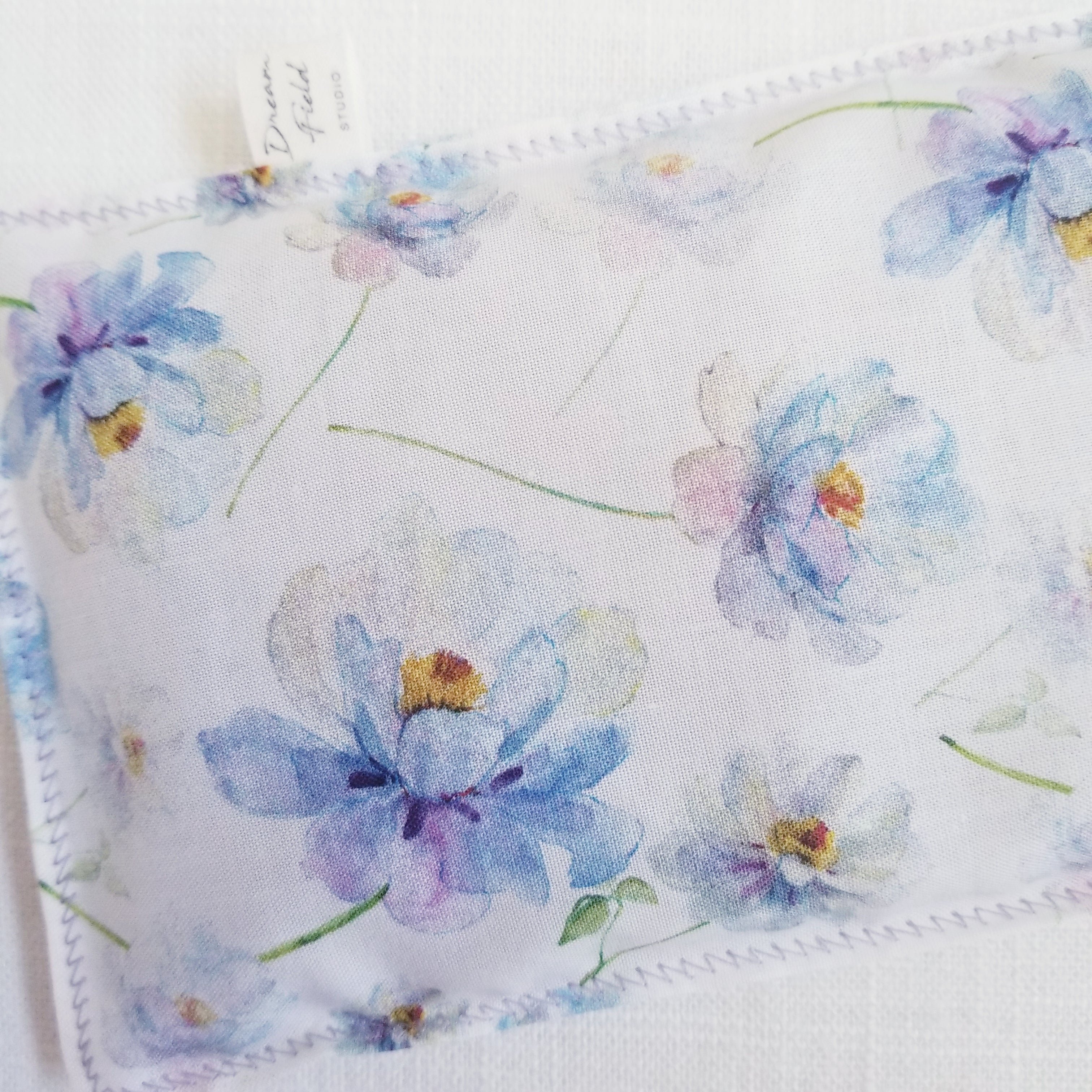 closeup of lavender dahlia flowers on eye pillow