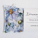 Closeup of blue watercolor daisy print eye pillow by Dream Field Studio