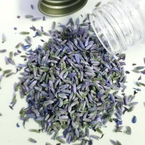 organic dried lavender buds falling out of bottle