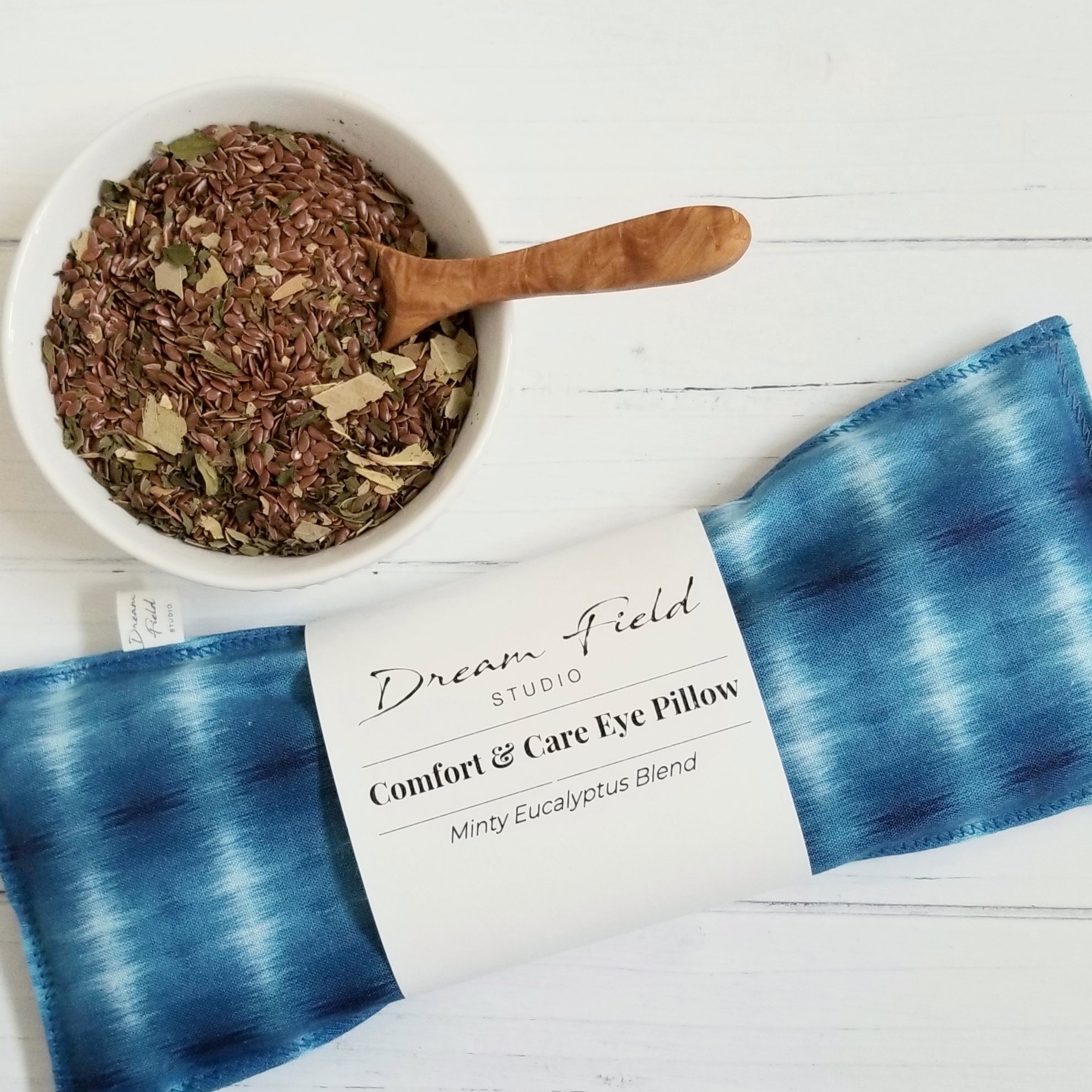 eucalyptus mint eye pillow shibori blue print and bowl of flax seeds and dried organic herbs